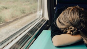 Woman sleeping on train in day time