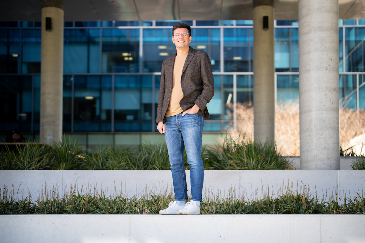 Dr Sergey Timonin says the study’s findings highlight the need for sustained public health efforts to help reduce inequalities in Australia. Photo: Jack Fox/ANU Profile photo of Dr Sergey Timonin standing next to a glass fronted building.