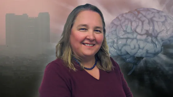 A smiling woman in a burgundy top with a large, realistic brain and a hazy cityscape in the background.