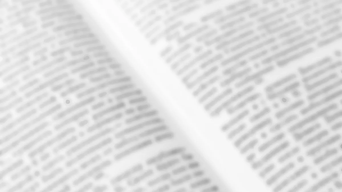 A blurred image of text in a book, making the content indiscernible.