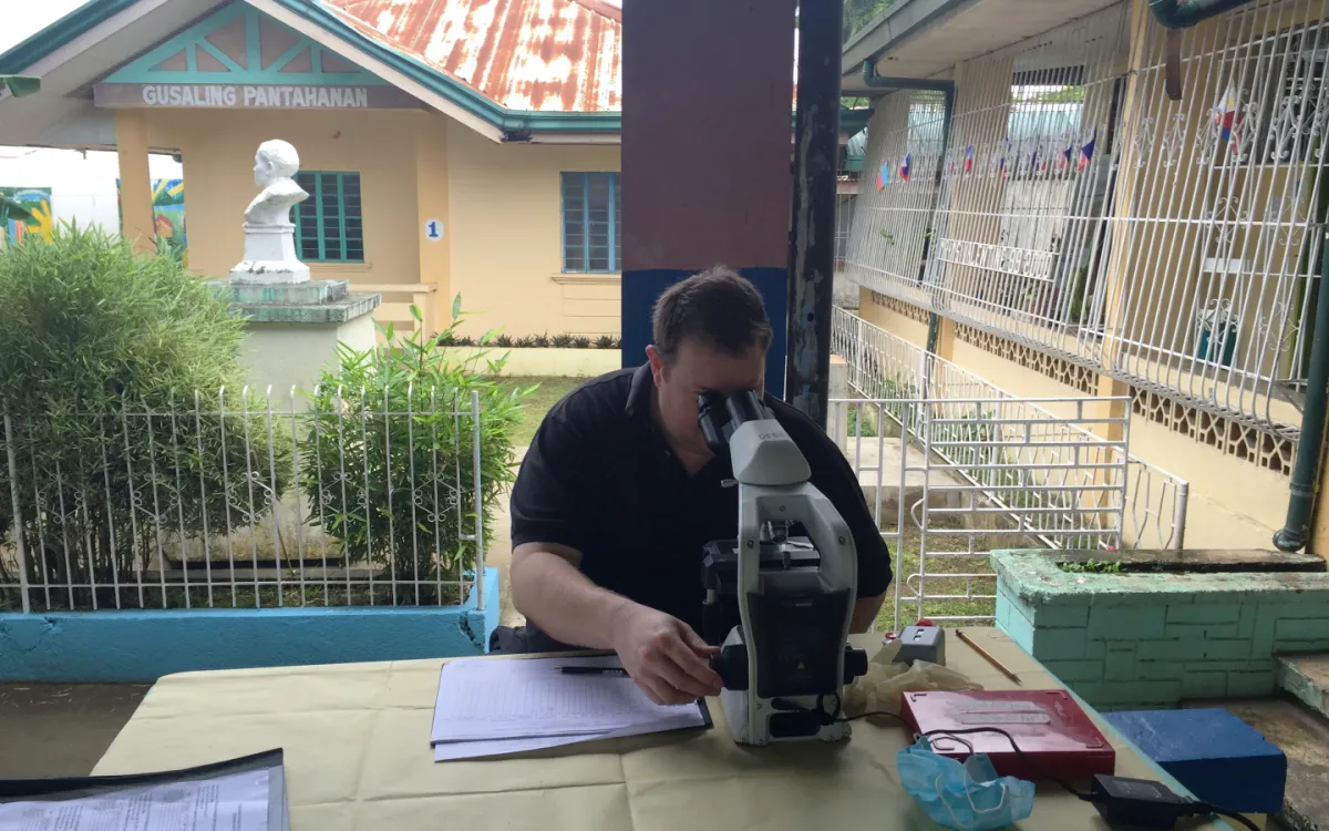 Professor Darren Gray looking at soil-transmitted helminth eggs