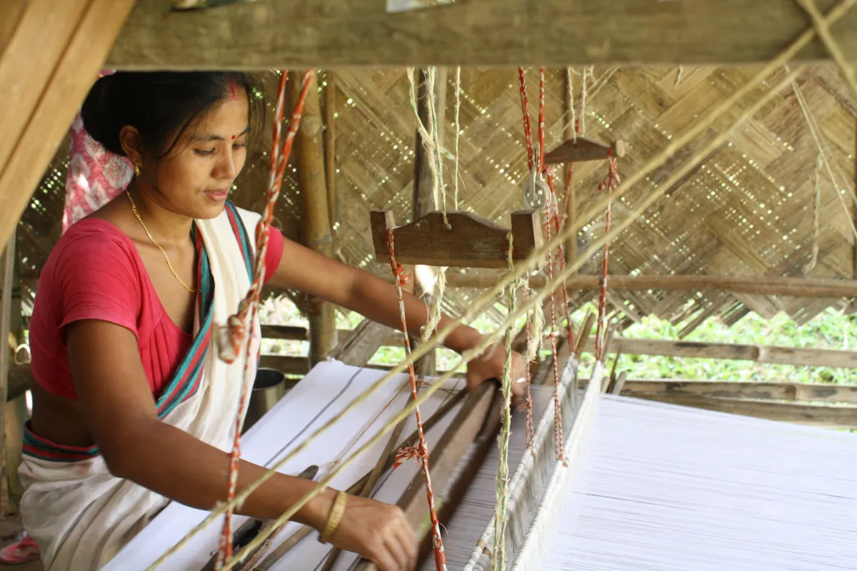 Rekha Doley, a Master Artisan with Impulse Empower, weaving from her home in Assam. Photo: Impulse Social Enterprises.