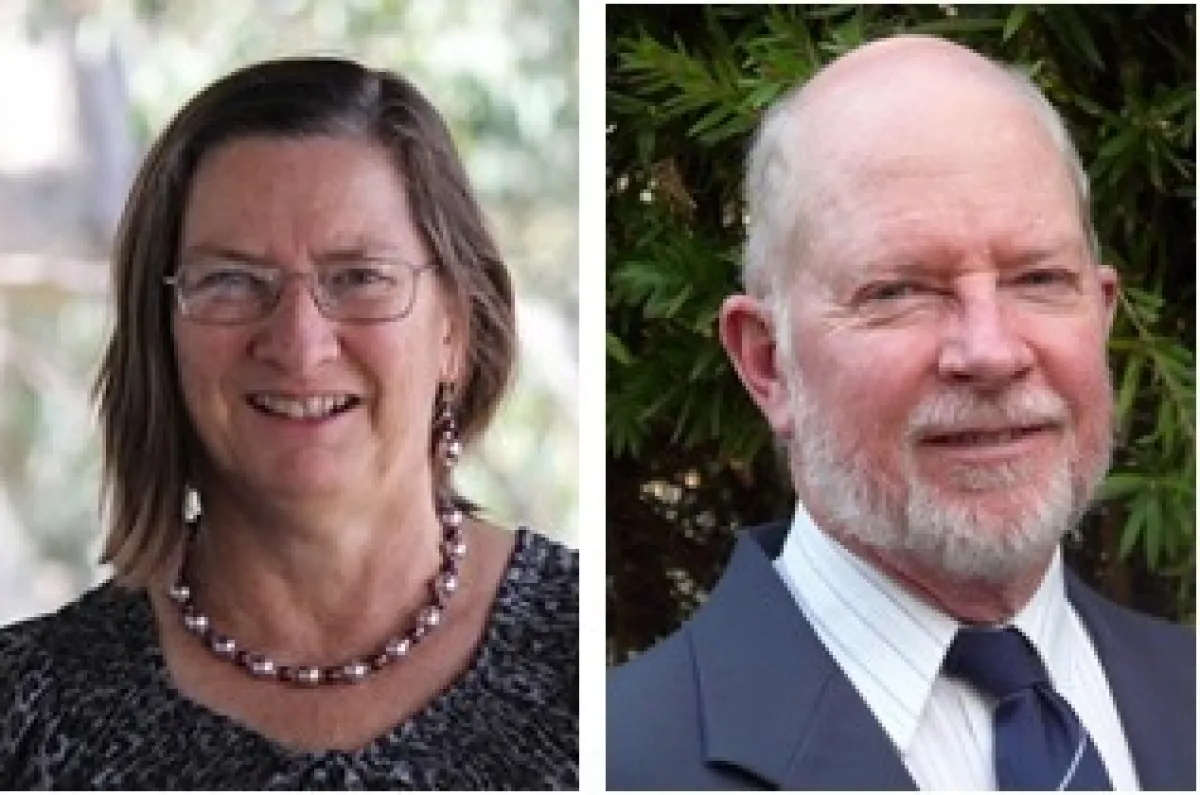 Portraits of a smiling woman wearing glasses and a necklace, and a smiling man with a beard in a suit and tie.