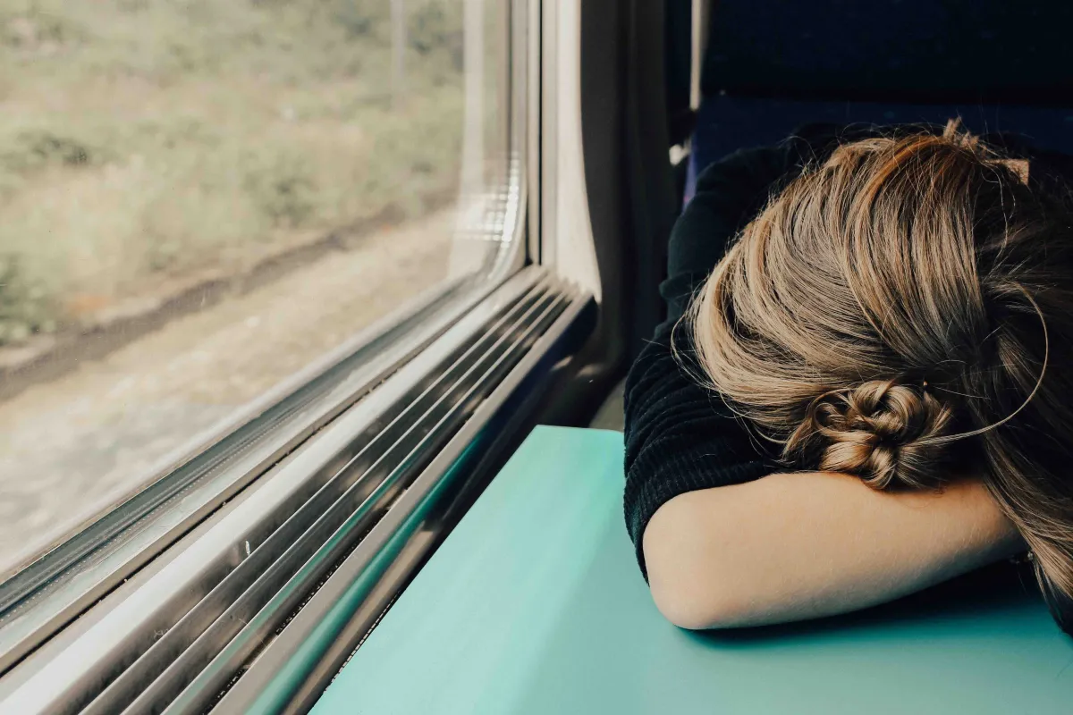Woman sleeping on train in day time