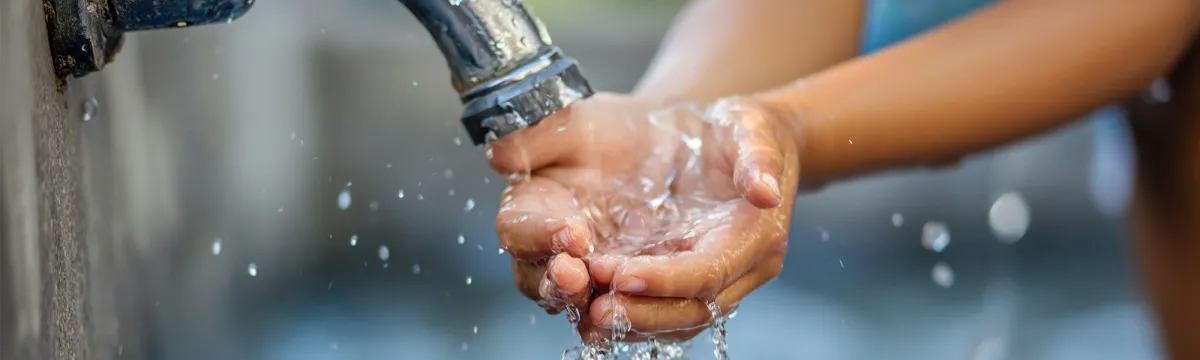 Close up of hands under a tap with running water