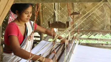 Rekha Doley, a Master Artisan with Impulse Empower, weaving from her home in Assam. Photo: Impulse Social Enterprises.